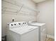 Well-equipped laundry room with modern washer and dryer beneath the metal wire shelving at 1015 Rexburg Dr, Cary, NC 27513