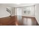 An open-concept living area with hardwood flooring, a staircase, and sliding doors to the backyard at 1015 Rexburg Dr, Cary, NC 27513
