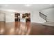 Open concept living space with hardwood floors seamlessly connecting living, dining, and kitchen areas at 1015 Rexburg Dr, Cary, NC 27513