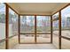 Enclosed back porch overlooking the backyard with a view of mature trees at 1015 Rexburg Dr, Cary, NC 27513