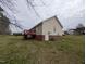 View of the backyard featuring the deck, HVAC unit, and access door at 1032 Holly Pointe Dr, Wendell, NC 27591