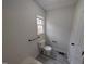 Bathroom features a tub with white surround, toilet, and window at 1032 Holly Pointe Dr, Wendell, NC 27591