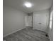Bedroom featuring gray plank floors, fresh paint, and closet storage at 1032 Holly Pointe Dr, Wendell, NC 27591