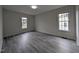 Bright bedroom with gray plank floors, neutral walls, and updated windows at 1032 Holly Pointe Dr, Wendell, NC 27591