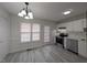 Bright dining area features new flooring, updated lighting, and stainless appliances at 1032 Holly Pointe Dr, Wendell, NC 27591