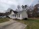 Charming single-story home with neutral siding, black shutters, and a cozy, white picket front porch at 1032 Holly Pointe Dr, Wendell, NC 27591
