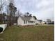 Charming single-story home with neutral siding, black shutters, and a cozy, white picket front porch at 1032 Holly Pointe Dr, Wendell, NC 27591
