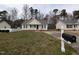 Charming single-story home with neutral siding, black shutters, and a cozy, white picket front porch at 1032 Holly Pointe Dr, Wendell, NC 27591