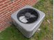 A gray HVAC unit installed at the rear of the house at 1032 Holly Pointe Dr, Wendell, NC 27591