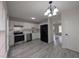 Kitchen featuring stainless steel appliances, white cabinets and backsplash, and gray wood-look floors at 1032 Holly Pointe Dr, Wendell, NC 27591