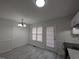 Bright kitchen featuring gray wood-look floors and storage and light from the window and door at 1032 Holly Pointe Dr, Wendell, NC 27591