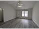 Bright living room with gray flooring, white door, and a large, sunlit window at 1032 Holly Pointe Dr, Wendell, NC 27591