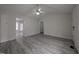Bright living room features vaulted ceilings, ceiling fan, and newly installed gray wood flooring at 1032 Holly Pointe Dr, Wendell, NC 27591