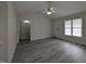 Bright living room features vaulted ceilings, ceiling fan, and newly installed gray wood flooring at 1032 Holly Pointe Dr, Wendell, NC 27591