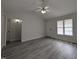 Bright living room features vaulted ceilings, ceiling fan, and newly installed gray wood flooring at 1032 Holly Pointe Dr, Wendell, NC 27591