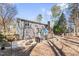 Spacious backyard with a patio, deck, landscaping, and mature trees at 104 Glenmore Rd, Cary, NC 27519