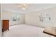 Large bedroom with carpeted floors, natural light, and a ceiling fan, and wood dresser at 104 Glenmore Rd, Cary, NC 27519