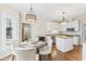 Charming breakfast nook features a round table with upholstered chairs near a sunny window at 104 Glenmore Rd, Cary, NC 27519