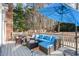 Relax on the deck with stylish outdoor seating, a colorful rug, and a view of the surrounding trees at 104 Glenmore Rd, Cary, NC 27519