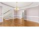 Elegant dining room features hardwood floors and a stylish chandelier, perfect for hosting gatherings at 104 Glenmore Rd, Cary, NC 27519