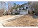 Charming two-story home with a manicured lawn, gray siding, dormer windows and a two car garage at 104 Glenmore Rd, Cary, NC 27519
