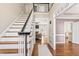 Welcoming foyer with a staircase, hardwood floors, and views into the living spaces at 104 Glenmore Rd, Cary, NC 27519