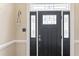 Elegant black front door with decorative glass and sidelights, offering a stylish entry at 104 Glenmore Rd, Cary, NC 27519