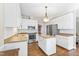 Open kitchen design with white cabinets, stainless appliances, and central island for meal prep at 104 Glenmore Rd, Cary, NC 27519
