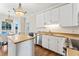 Bright kitchen featuring white cabinets, subway tile backsplash, and stainless steel appliances at 104 Glenmore Rd, Cary, NC 27519