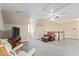 Spacious bonus room with an accent chair and staircase and a modern ceiling fan at 104 Glenmore Rd, Cary, NC 27519