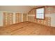 An unfinished attic room with wood floors, drywall, and a window providing natural light at 104 Parker St, Oxford, NC 27565