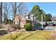 The backyard features a brick detached garage, a patio with cover and mature trees at 104 Parker St, Oxford, NC 27565