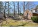 A spacious backyard features a detached garage, storage shed, partial fencing and mature trees at 104 Parker St, Oxford, NC 27565