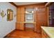 Classic bathroom with custom vanity, wood floors, vintage sconces, and floral wallpaper at 104 Parker St, Oxford, NC 27565