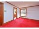 Bedroom showcasing wood trim, a window for natural light, and doorway view into an adjacent room at 104 Parker St, Oxford, NC 27565
