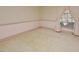 A bright bedroom with a large window dressed with curtains, tan carpet, and pastel-patterned wallpaper at 104 Parker St, Oxford, NC 27565
