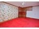 A bedroom with red carpet, custom built-in storage and shelving, and cartoon wallpaper at 104 Parker St, Oxford, NC 27565