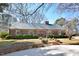 A brick home is beautifully landscaped with trimmed bushes and a brick walkway at 104 Parker St, Oxford, NC 27565