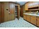 Functional laundry area featuring ample cabinet space and laminate flooring at 104 Parker St, Oxford, NC 27565