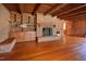 Warm living room with a brick fireplace, built-in shelving, and gleaming hardwood floors at 104 Parker St, Oxford, NC 27565