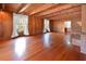 Expansive living room showcasing hardwood floors, exposed beams, and natural light from large windows at 104 Parker St, Oxford, NC 27565
