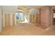 An unfinished living room with brick fireplace, large window, wood floors, and natural light at 104 Parker St, Oxford, NC 27565