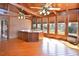 Sunroom with hot tub, exposed wood beams, and multiple windows at 104 Parker St, Oxford, NC 27565