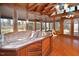 Sunroom featuring a hot tub, wood floors, and floor-to-ceiling windows at 104 Parker St, Oxford, NC 27565