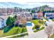 Aerial view of a two-story home with a landscaped front yard in a neighborhood with mature trees at 105 Presley Snow Ct, Holly Springs, NC 27540