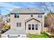 Back of home with large windows, a patio, and a lush lawn at 105 Presley Snow Ct, Holly Springs, NC 27540