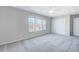 Neutral bedroom featuring a ceiling fan and carpet floors at 105 Presley Snow Ct, Holly Springs, NC 27540