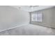 Neutral bedroom featuring new carpet, a ceiling fan, and a bright window at 105 Presley Snow Ct, Holly Springs, NC 27540
