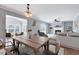 Dining area with a view into the living room with fireplace and natural light at 105 Presley Snow Ct, Holly Springs, NC 27540