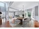 Elegant dining room with wood floors, stylish lighting, and an open layout at 105 Presley Snow Ct, Holly Springs, NC 27540